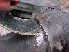 turn your grinder so that you can 
<br />grind a little into the cast wedge so 
<br />that you crack the weld